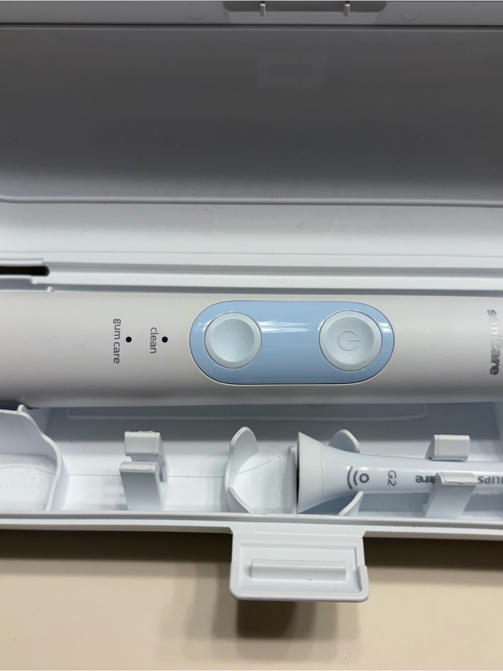 2 Sonic Electric Toothbrushes in White and Light Blue—same model, diff designs